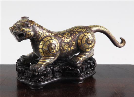 A Chinese parcel gilt bronze figure of a tiger, in Song dynasty style, length 18cm, together with a fitted hardwood box